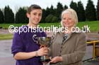 Michael Wilson (Sunderland) receives the Jimmy Hedley 800 metres Cup from Diane Holmes, daughter of the late Jimmy Hedley, North Eastern Grand Prix, Monkton Stadium, Jarrow. Photo: David T. Hewitson/Sports for All Pics